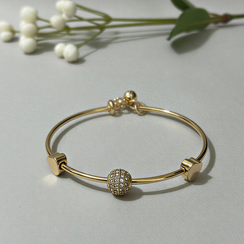 Elegant Crystal Globe & Golden Heart Charm Bangle