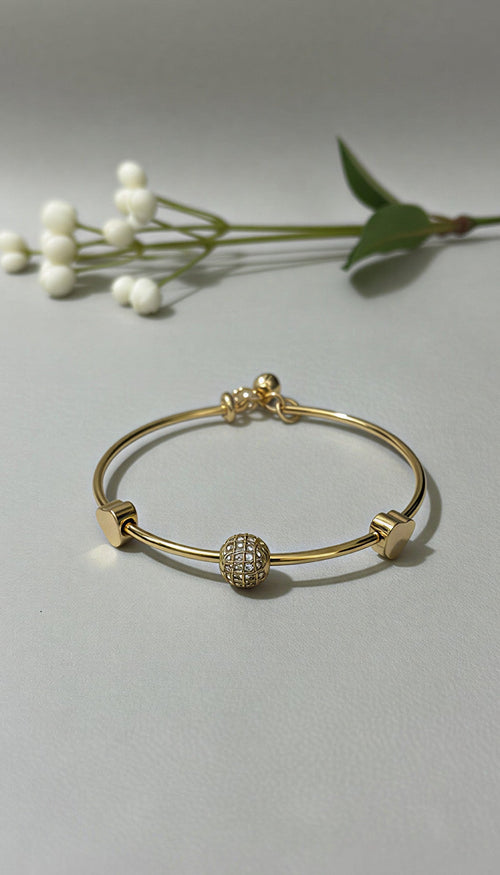Elegant Crystal Globe & Golden Heart Charm Bangle