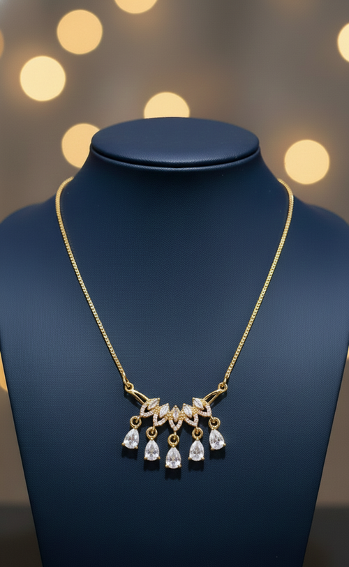 Lumina Luxe tiered statement necklace featuring a nature-inspired golden-tone fan centerpiece with five hanging teardrop-cut crystals, available in multiple gemstone-inspired colors including Ruby, Emerald, Onyx, and Diamond-inspired tones