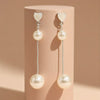 Elegant Dual-Pearl Drop Earrings – High-Shine Geometric Studs.