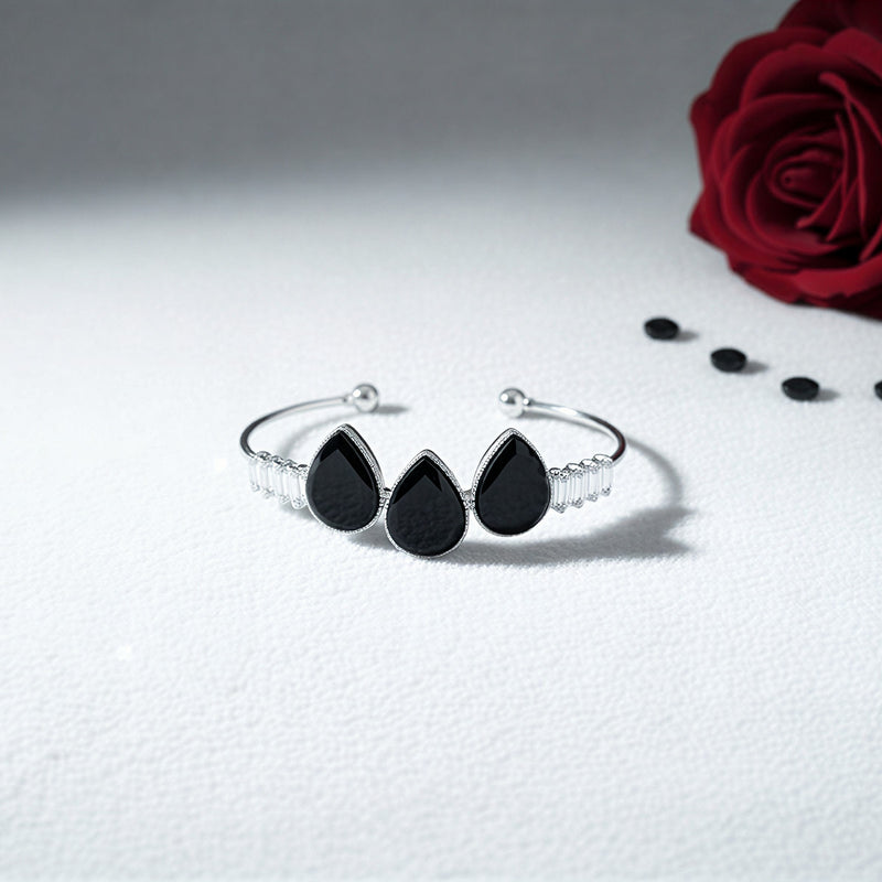 Flexible open-cuff bangle with a pavé crystal heart and dangling pearl.