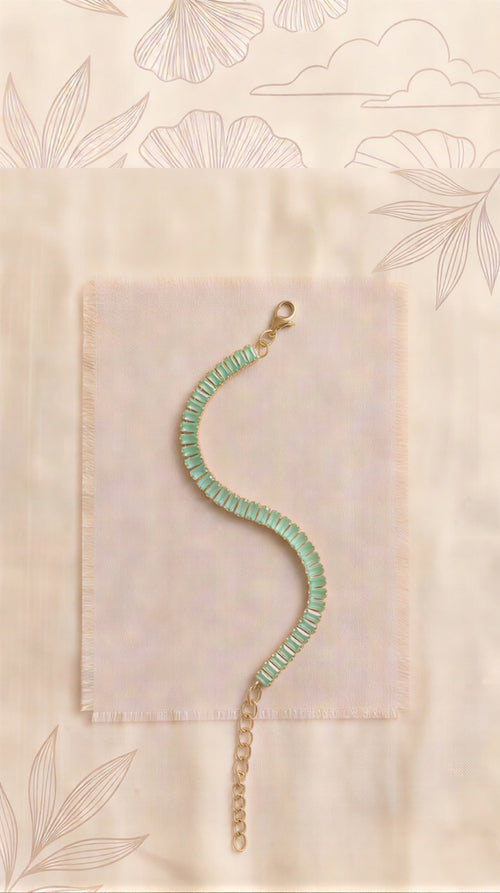 The Serene Sea-Foam Baguette: Elite Single-Strand Tennis Bracelet Featuring Sea-Green Emerald-Cut Crystals in a Radiant Gold-Tone Adjustable Frame