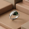 The Emerald Majesty: A Sophisticated Pear-Cut Emerald Green Statement Ring with Radiant Baguette Diamond Accents in a High-Definition Silver Finish