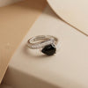 A Sophisticated Adjustable Ring with a Soft Pink Teardrop Stone and Precision-Set Crystals in Dual Metallic Finishes.