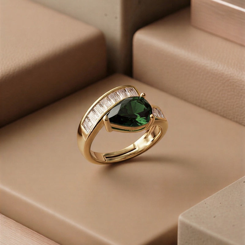 The Emerald Majesty: A Sophisticated Pear-Cut Emerald Green Statement Ring with Radiant Baguette Diamond Accents in a High-Definition Silver Finish