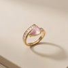 A Sophisticated Adjustable Ring with a Soft Pink Teardrop Stone and Precision-Set Crystals in Dual Metallic Finishes