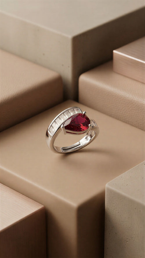 An Elite Adjustable Gold-Plated Ring Featuring a Deep Red Teardrop Stone and Precision-Set Baguette Zircons.