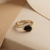 A Sophisticated Adjustable Ring with a Soft Pink Teardrop Stone and Precision-Set Crystals in Dual Metallic Finishes.