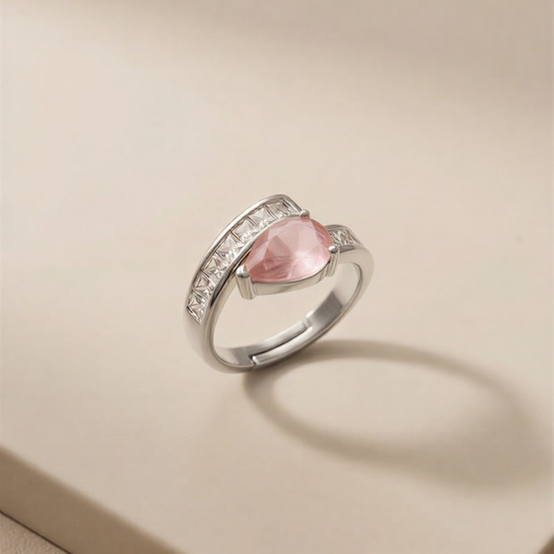 A Sophisticated Adjustable Ring with a Soft Pink Teardrop Stone and Precision-Set Crystals in Dual Metallic Finishes