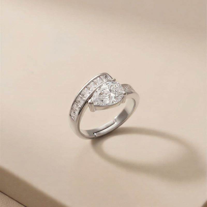 A Transcendent Pear-Shaped Crystal Masterpiece Featuring Geometric Baguette Alignment, Available in Radiant Gold and Sterling Silver Tones.