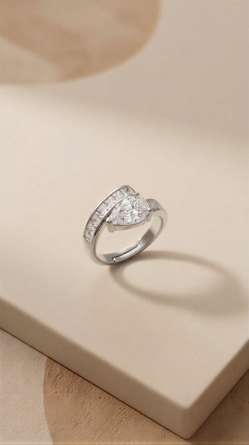 A Transcendent Pear-Shaped Crystal Masterpiece Featuring Geometric Baguette Alignment, Available in Radiant Gold and Sterling Silver Tones.